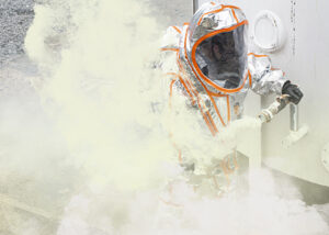 Worker in an aluminized Frontline 500 flash-fire suit venting chemical vapor