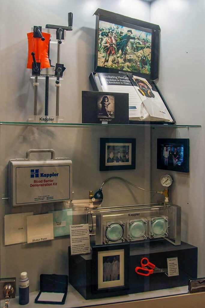 Kappler Museum case with the Blood Barrier Demonstration Kit, permeation test glove box, and historical artifacts
