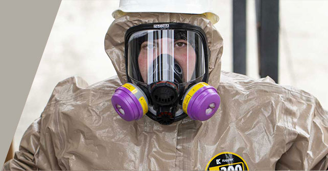 Close-up of a worker in a Kappler Zytron 300 suit and full-face respirator with Z300 badge